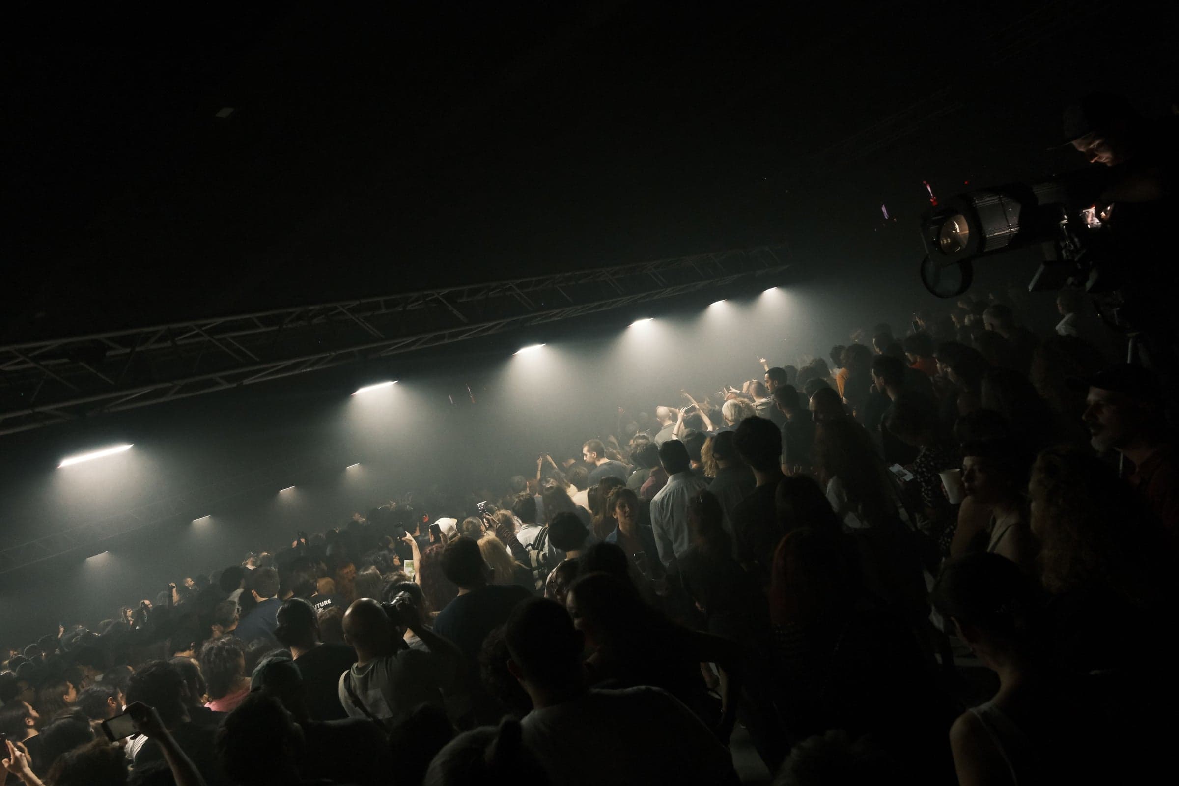 The audience under the stage lights at UNBURNED