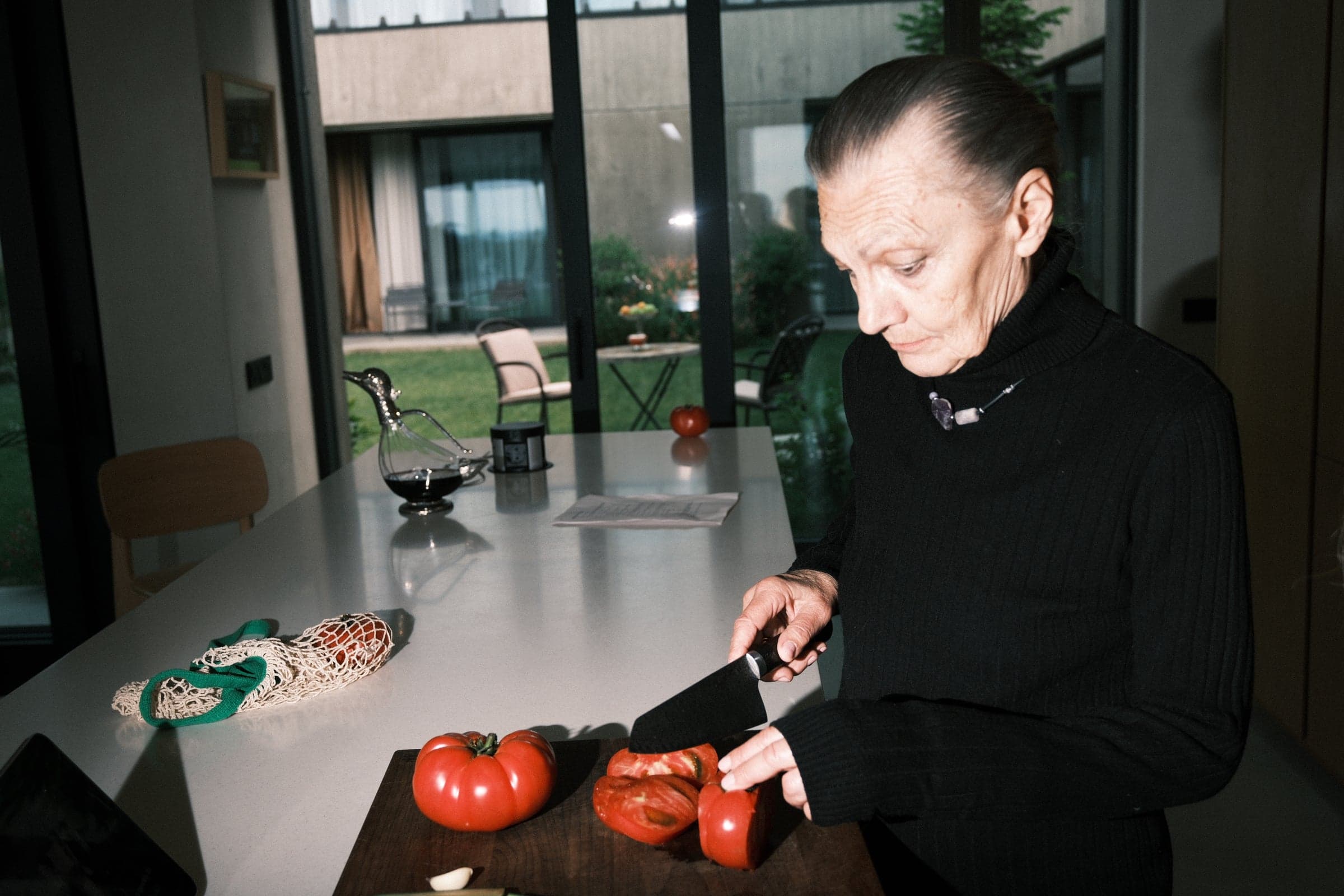 A performer slicing tomatoes in a kitchen